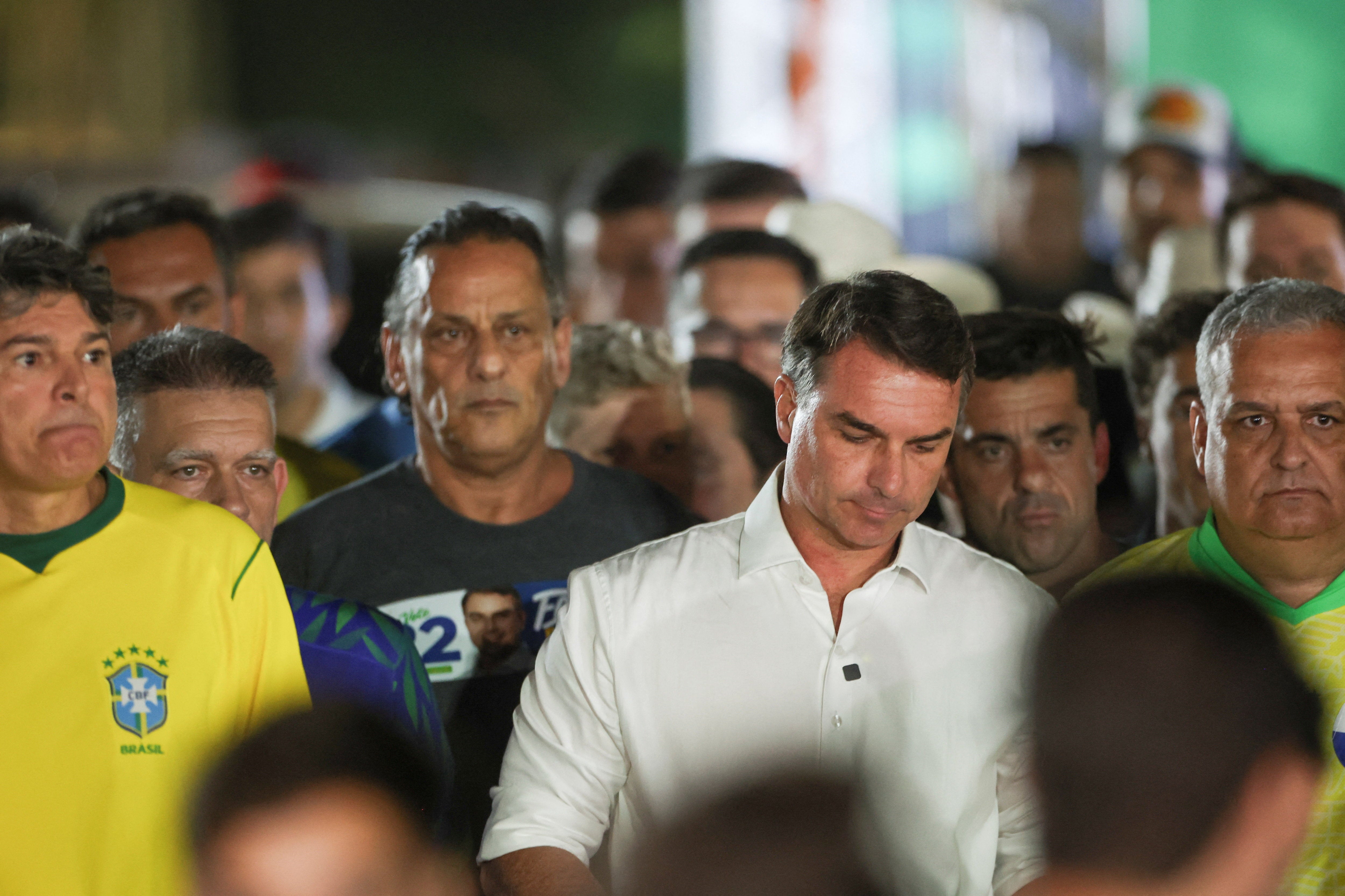 Flavio Bolsonaro, pictured in white, questioned a decision to extend voting by two hours