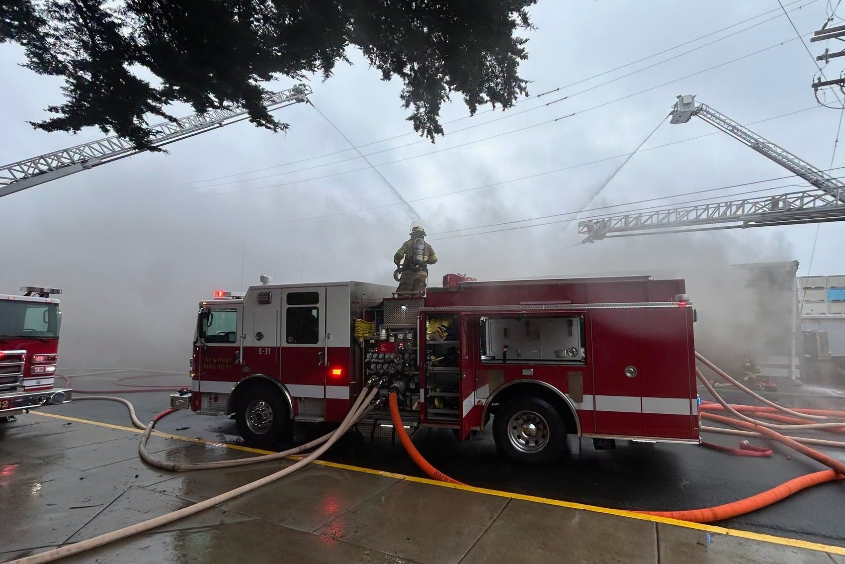 This photo provided by the Oregon State Fire Marshall shows firefighters trying to extinguish a fire at a seafood wholesaler in Newport