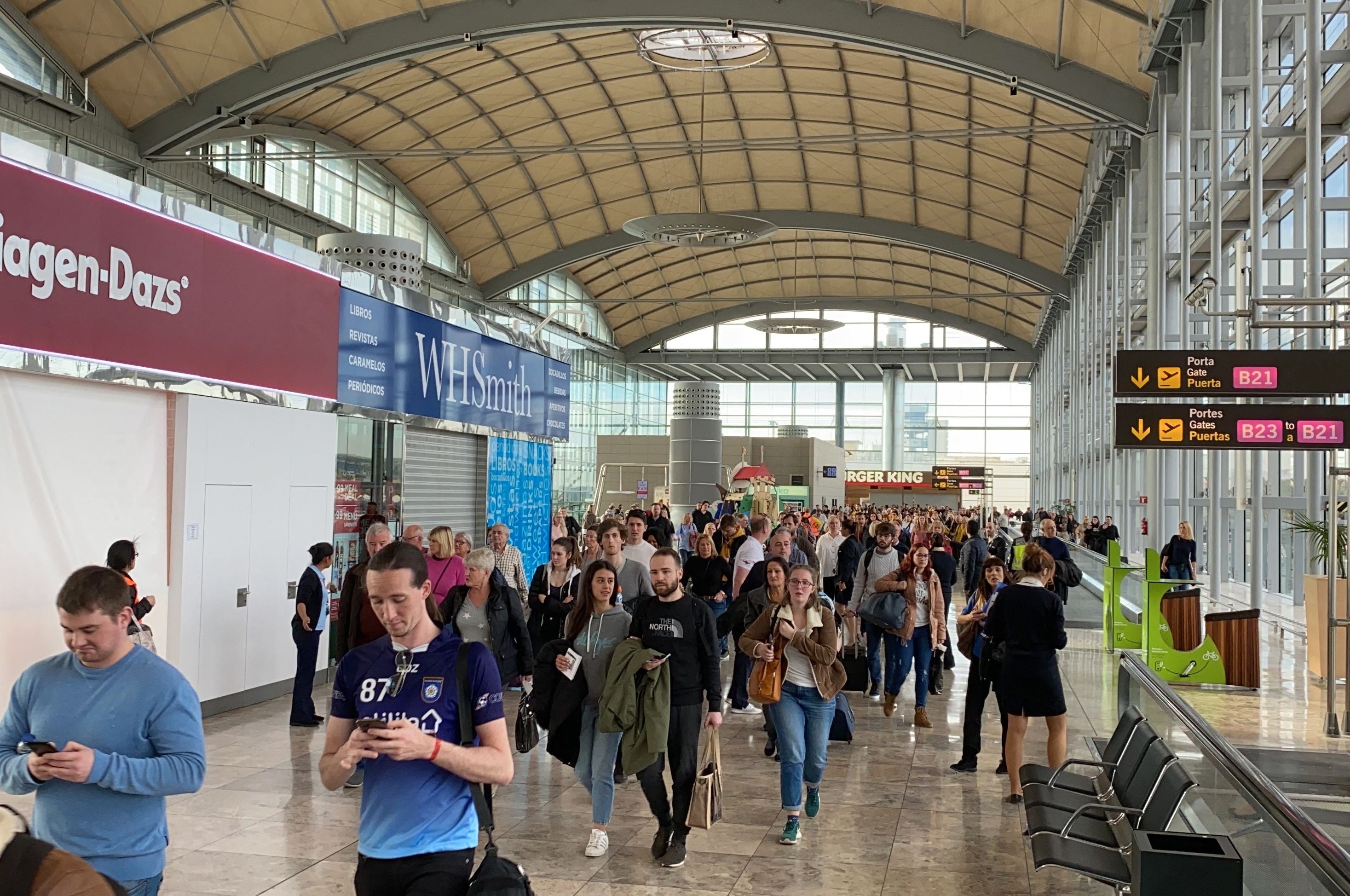 Passengers are evacuated at Alicante-Elche airport on January 15, 2020 in Alicante after a fire erupted in the terminal