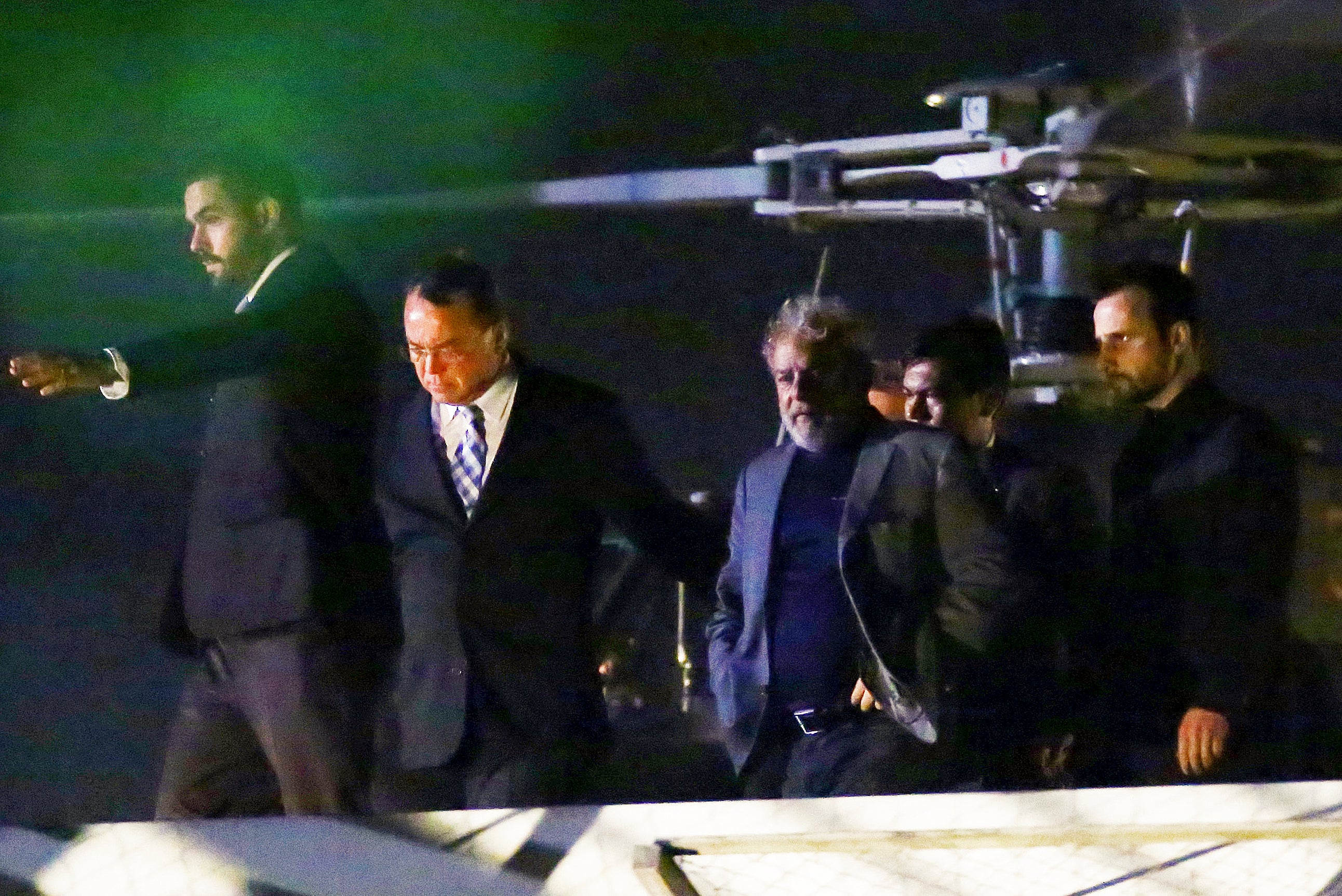 Lula (C) arrives at the Federal Police headquarters to start a 12-year prison sentence, in Curitiba, in 2018, after agreeing to comply with an arrest warrant