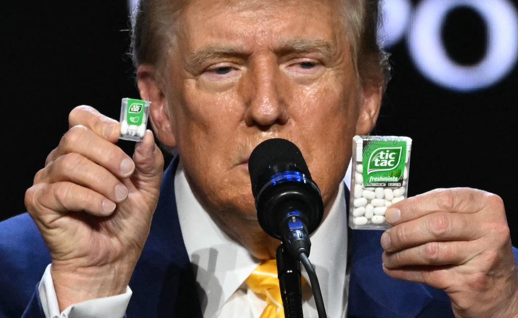 Trump holds a big and a small box of tic-tac to illustrate inflation outcome during a town hall event at Dream City Church in Phoenix, Arizona, on June 6, 2024