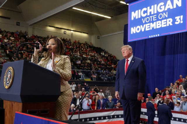 Trump appears to be taking it all in as Minaj speaks during the rally in support of Mike Rogers in Port Huron, Michigan, on Sunday
