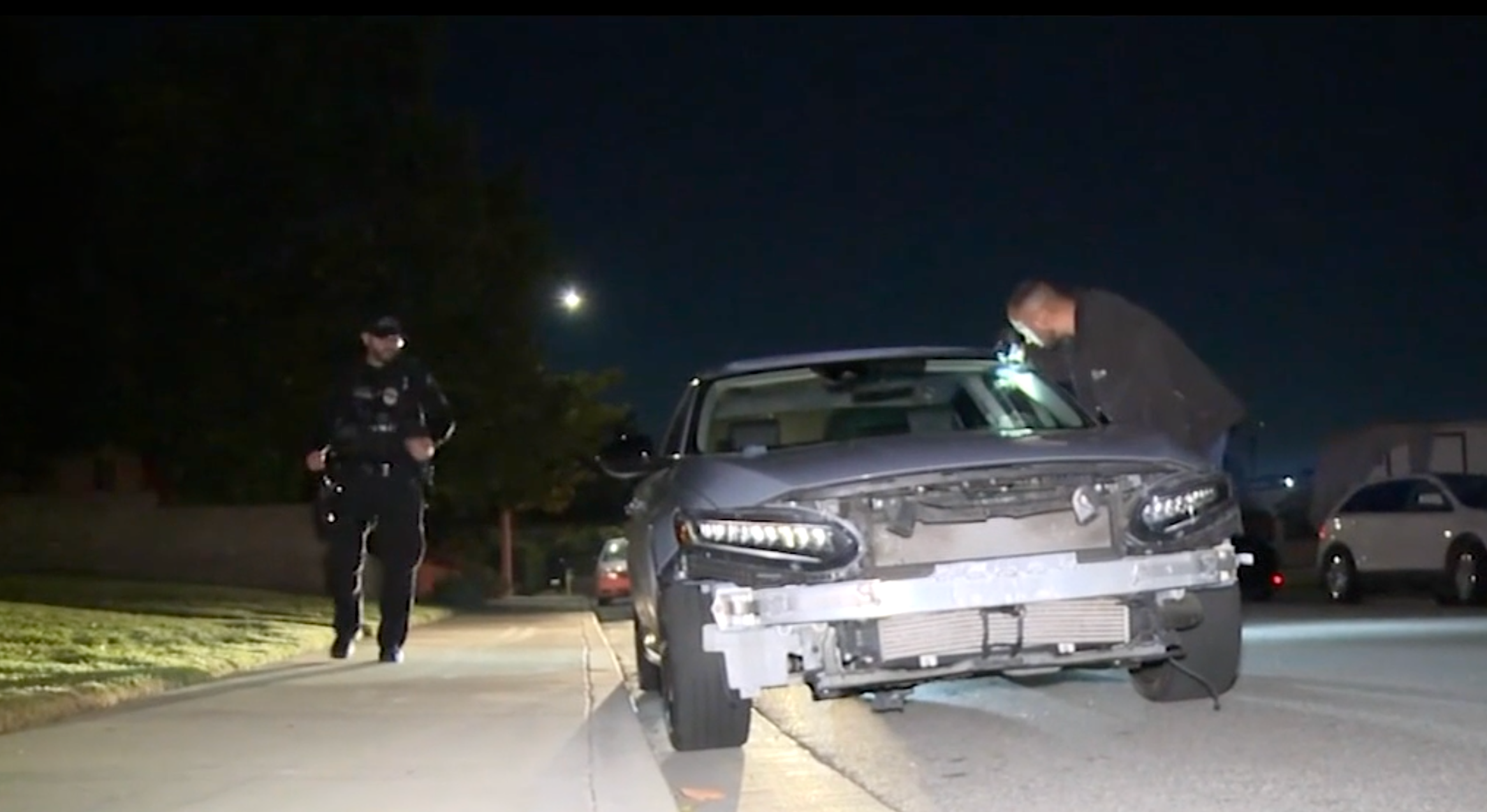 Detectives examine a damaged car thought to have been involved in the deadly collision in Montclair in which a group of Halloween cyclists were hit by a suspected DUI driver