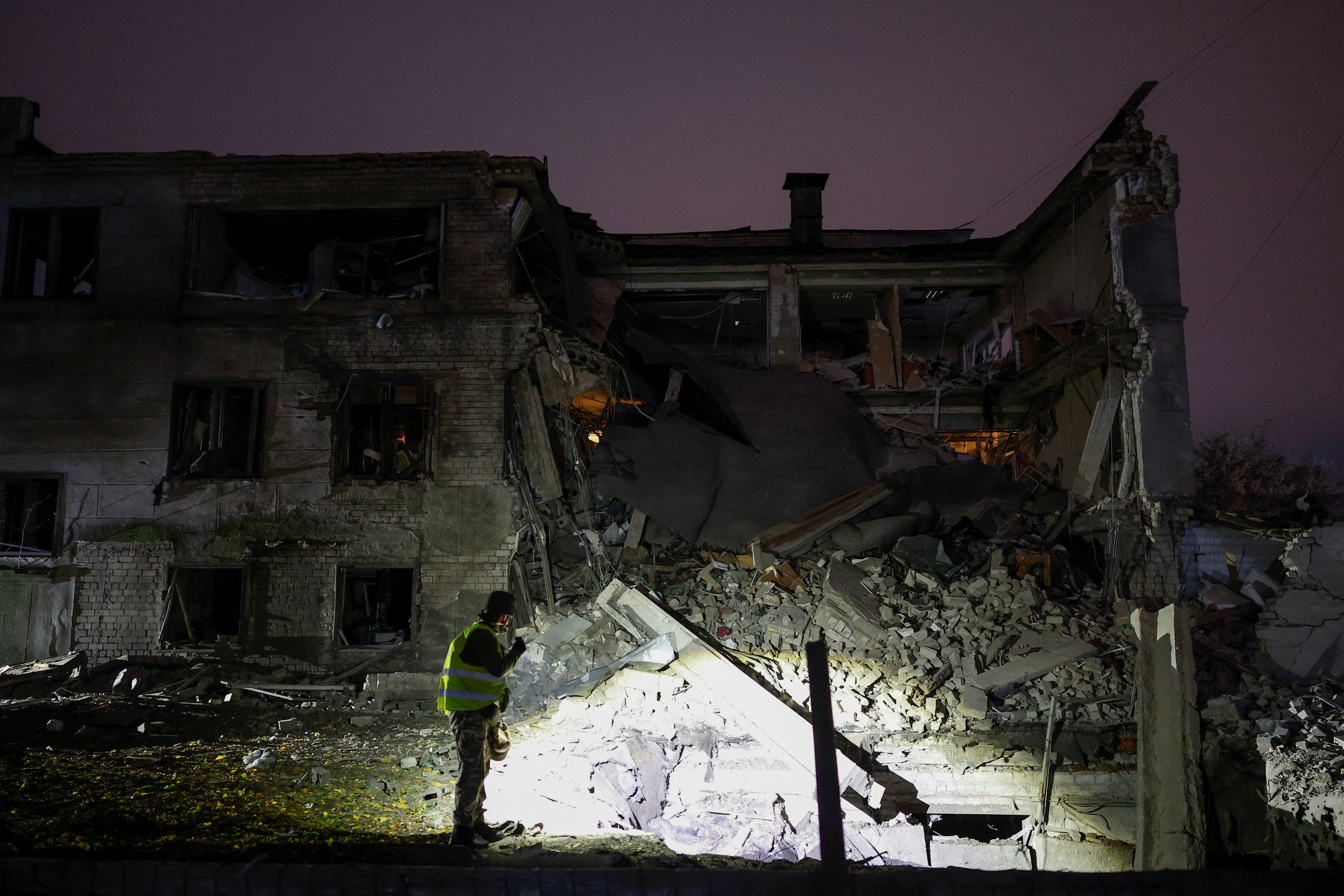 A police officer inspects the site of a food production facility hit by a Russian missile strike