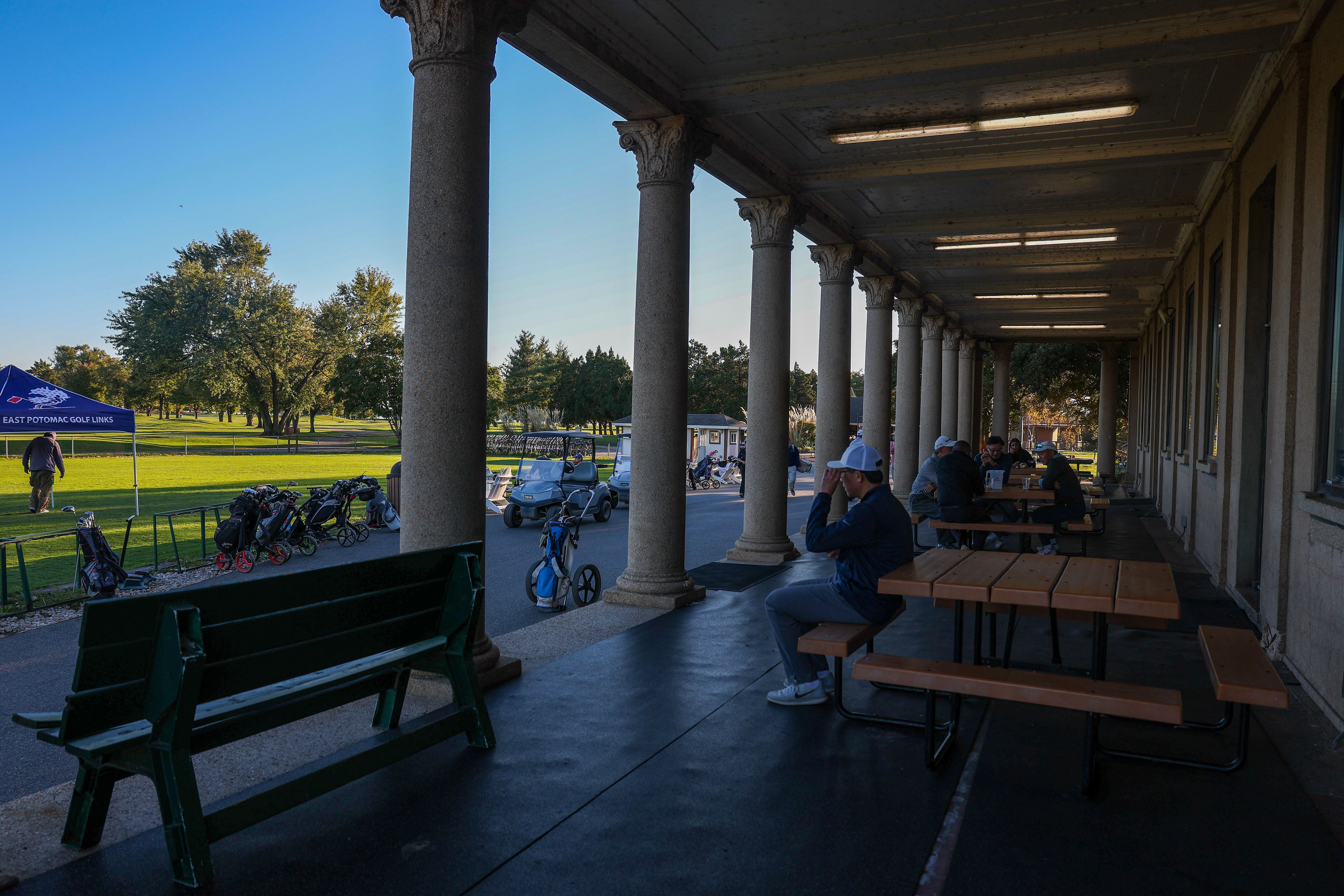 Golfers make their way around the course at East Potomac Golf Links on October 18