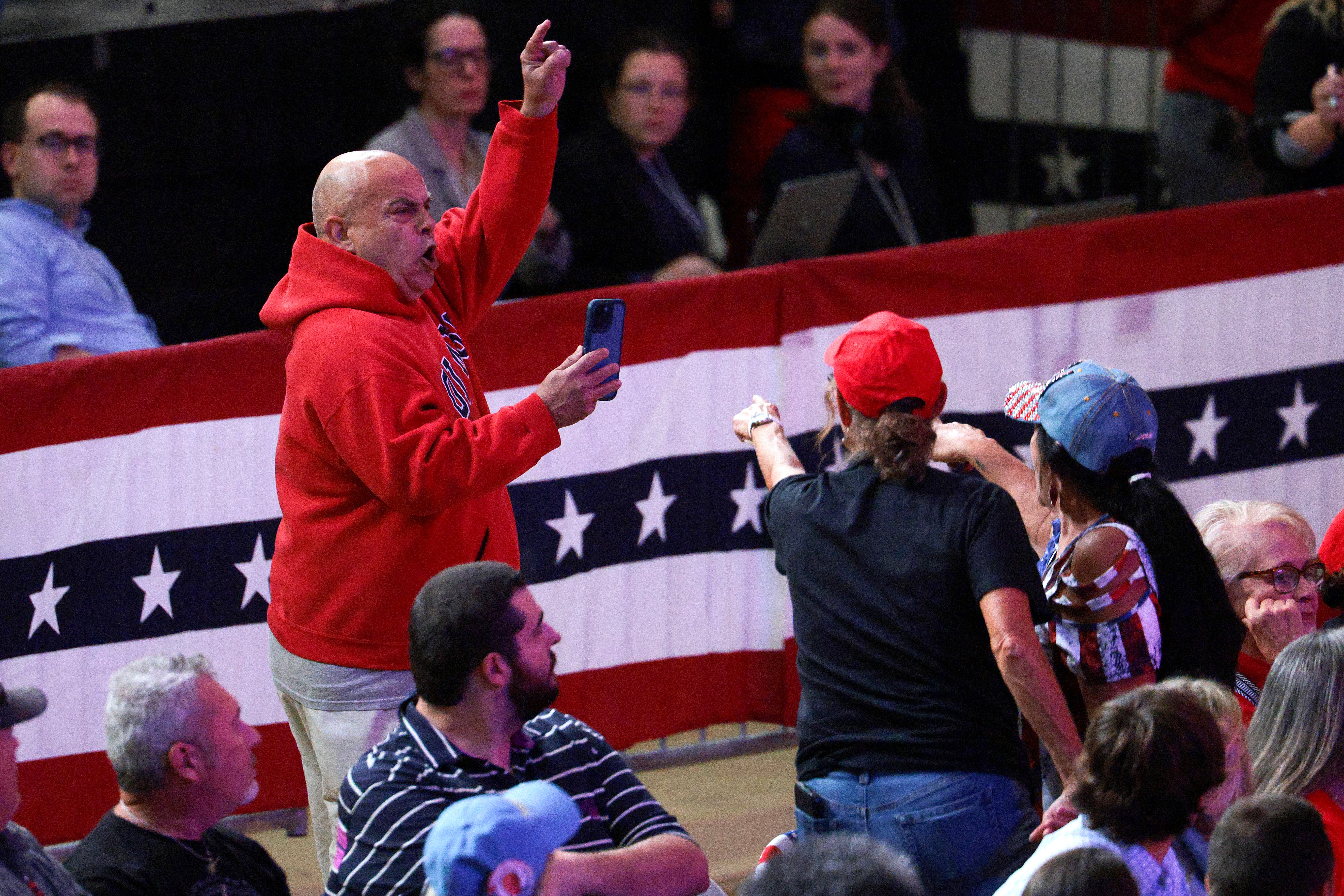 The protester was escorted away as the crowd chanted 'USA'