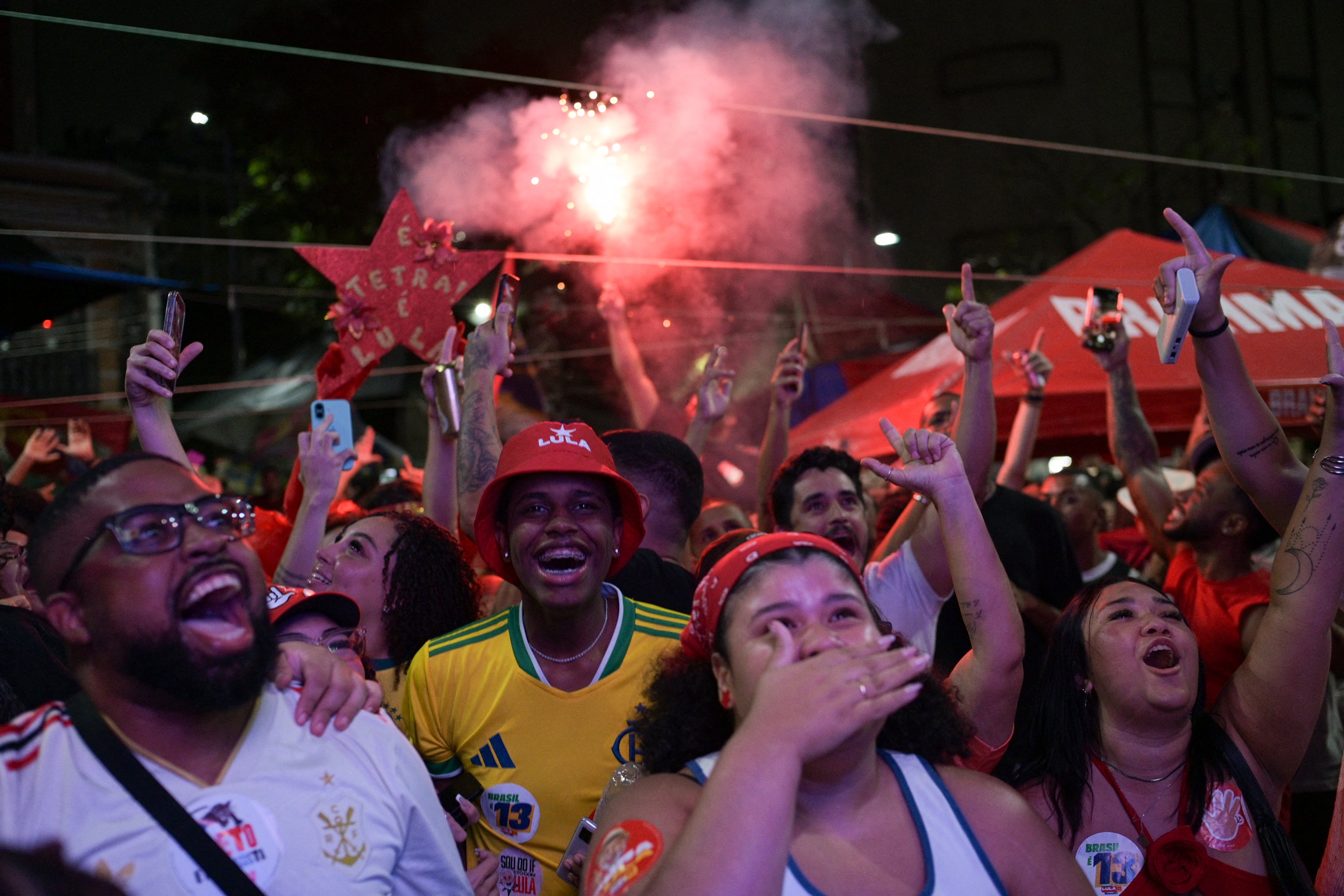 Supporters of Brazil's President and Workers' Party (PT) re-election candidate Luiz Inacio Lula da Silva watch the results on a large screen during the presidential runoff election in Rio de Janeiro, Brazil, on October 25, 2026