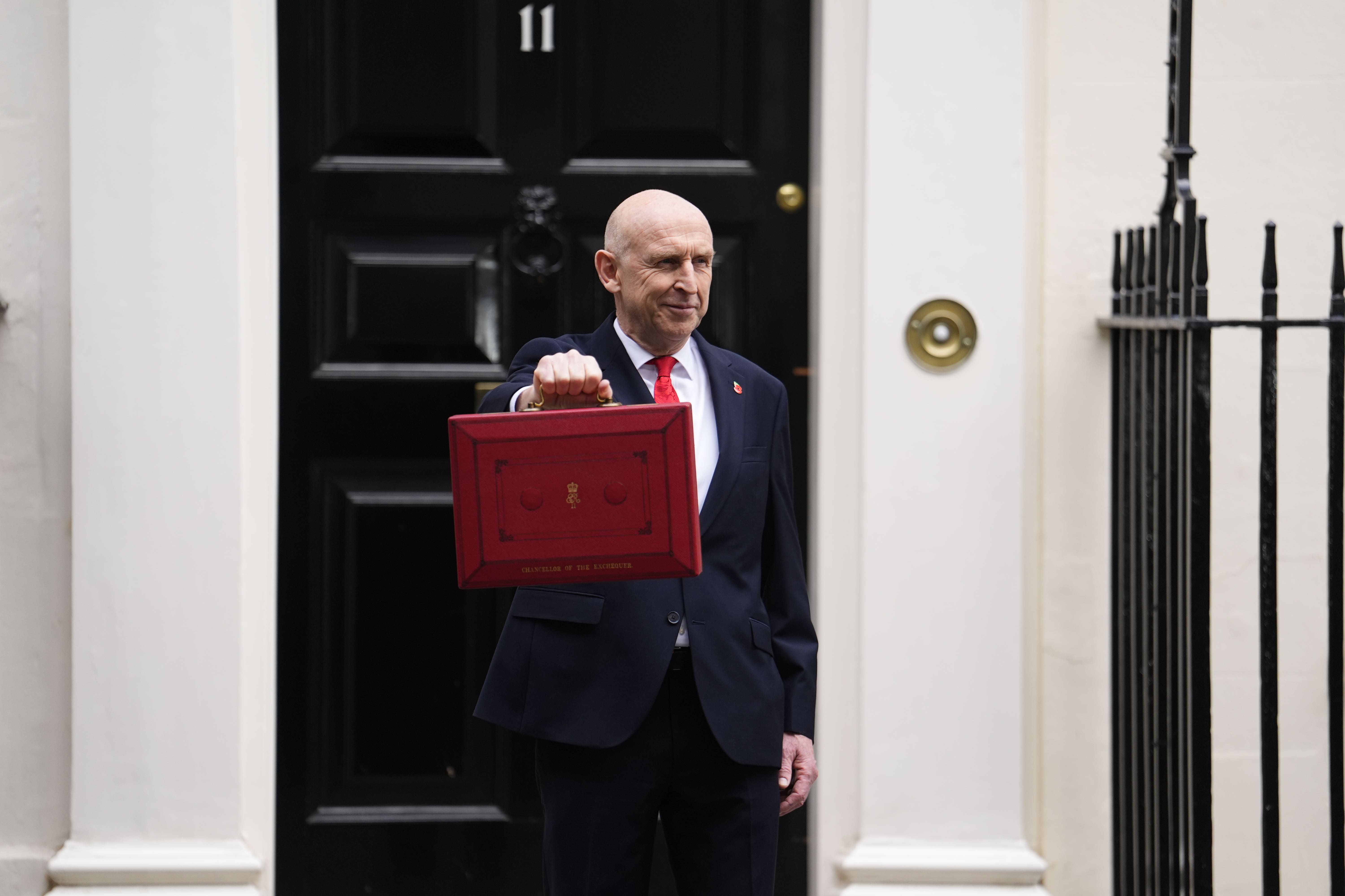 Chancellor of the Exchequer John Healey poses for photographs as he leaves 11 Downing Street before delivering his first Budget (Jordan Pettitt/PA)