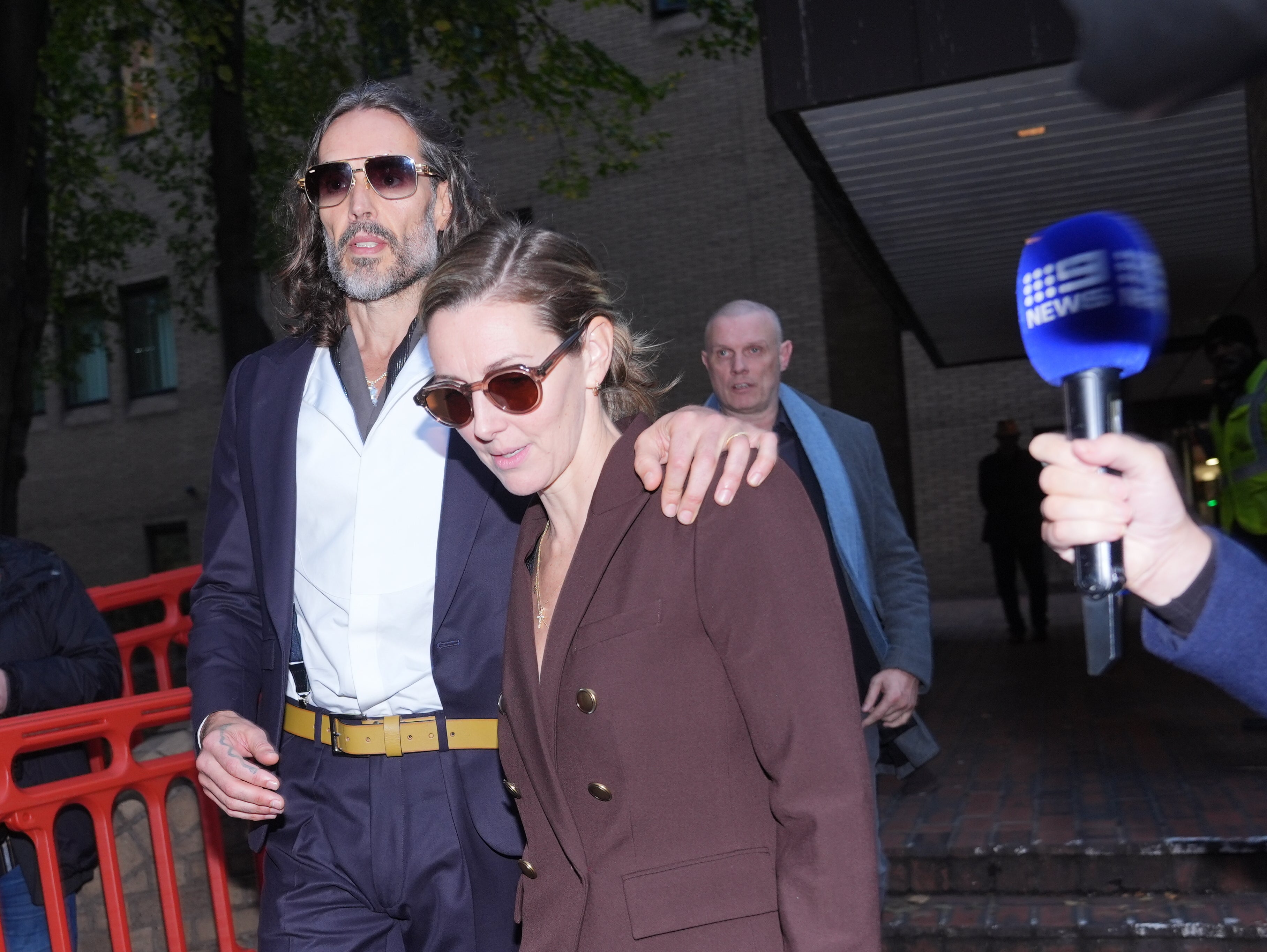 Brand leaving court with his wife, Laura Gallacher