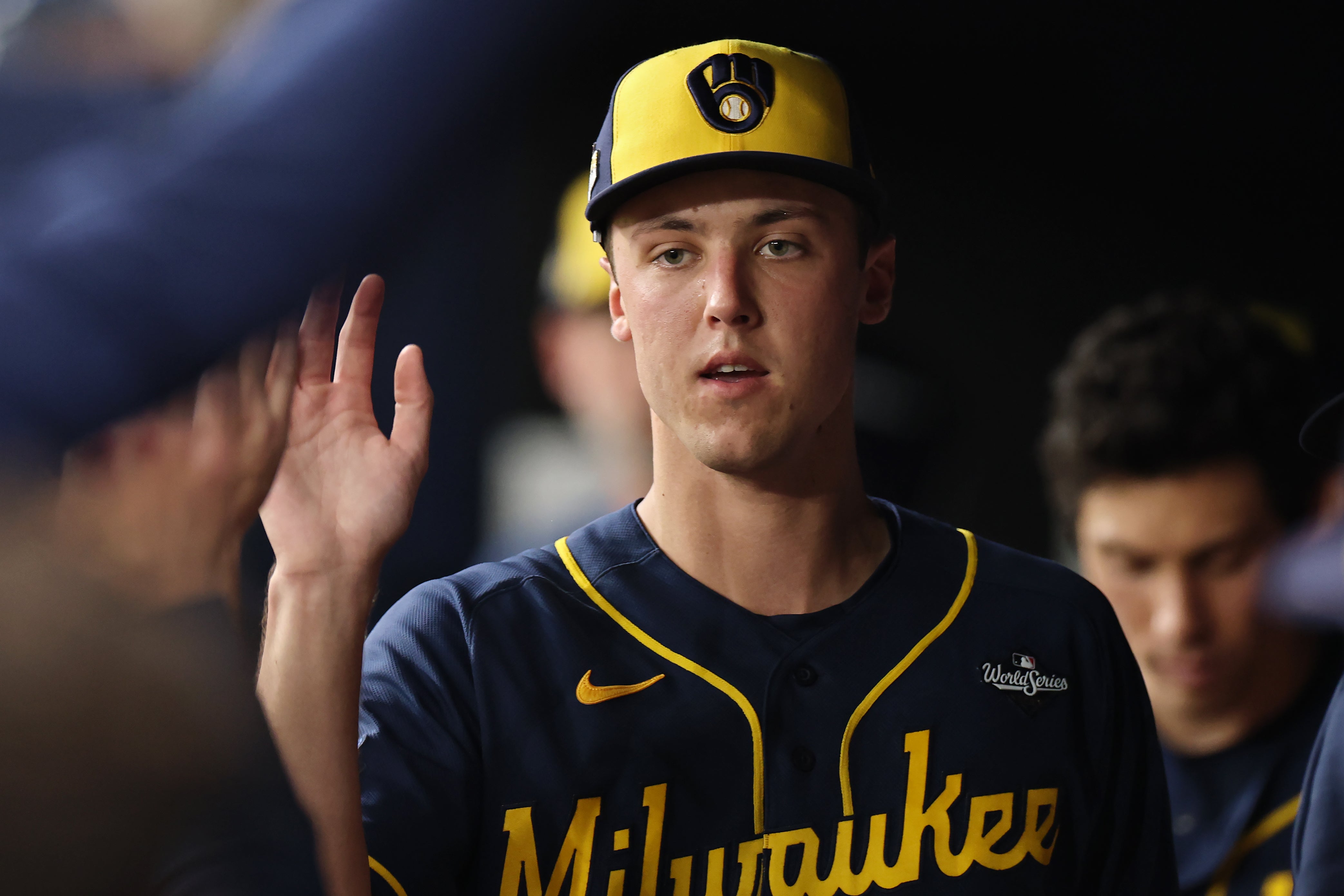 Jacob Misiorowski #32 of the Milwaukee Brewers interacts with teammates in the dugout