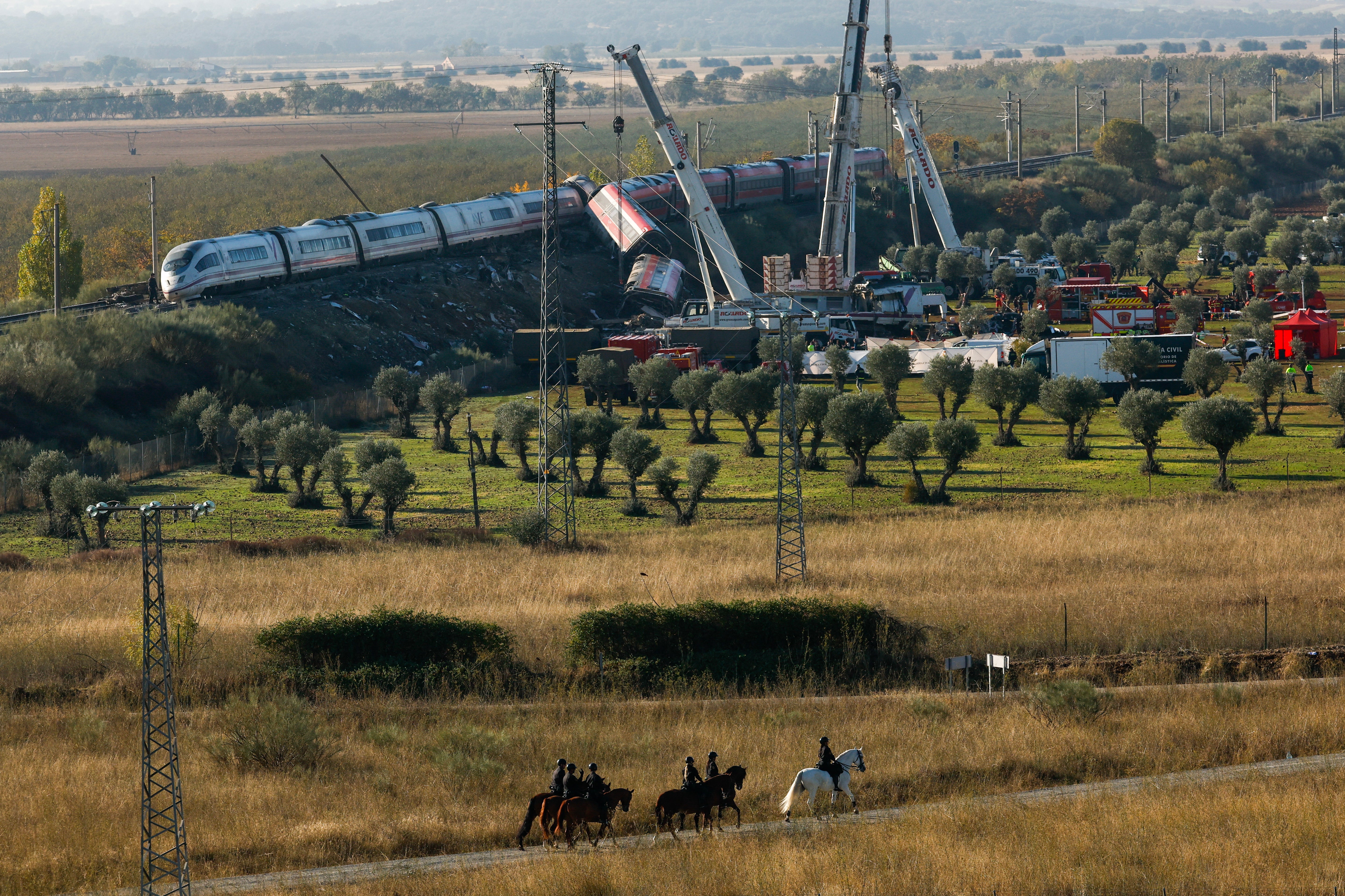 Cranes lifted the wreckage overnight in a search for survivors