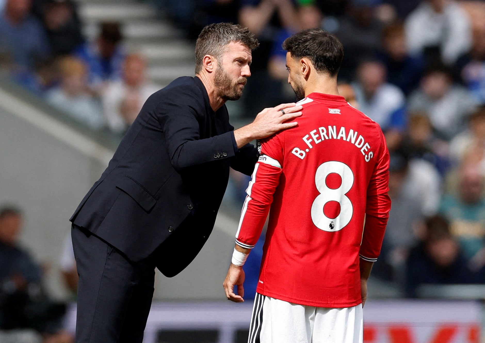 Manchester United manager Michael Carrick speaks to Bruno Fernandes