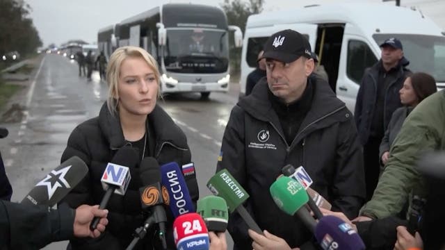 Yana Lantratova (L) with Ukrainian human rights ombudsman Dmytro Lubinets in front of an aid convoy on Friday ( Reuters )