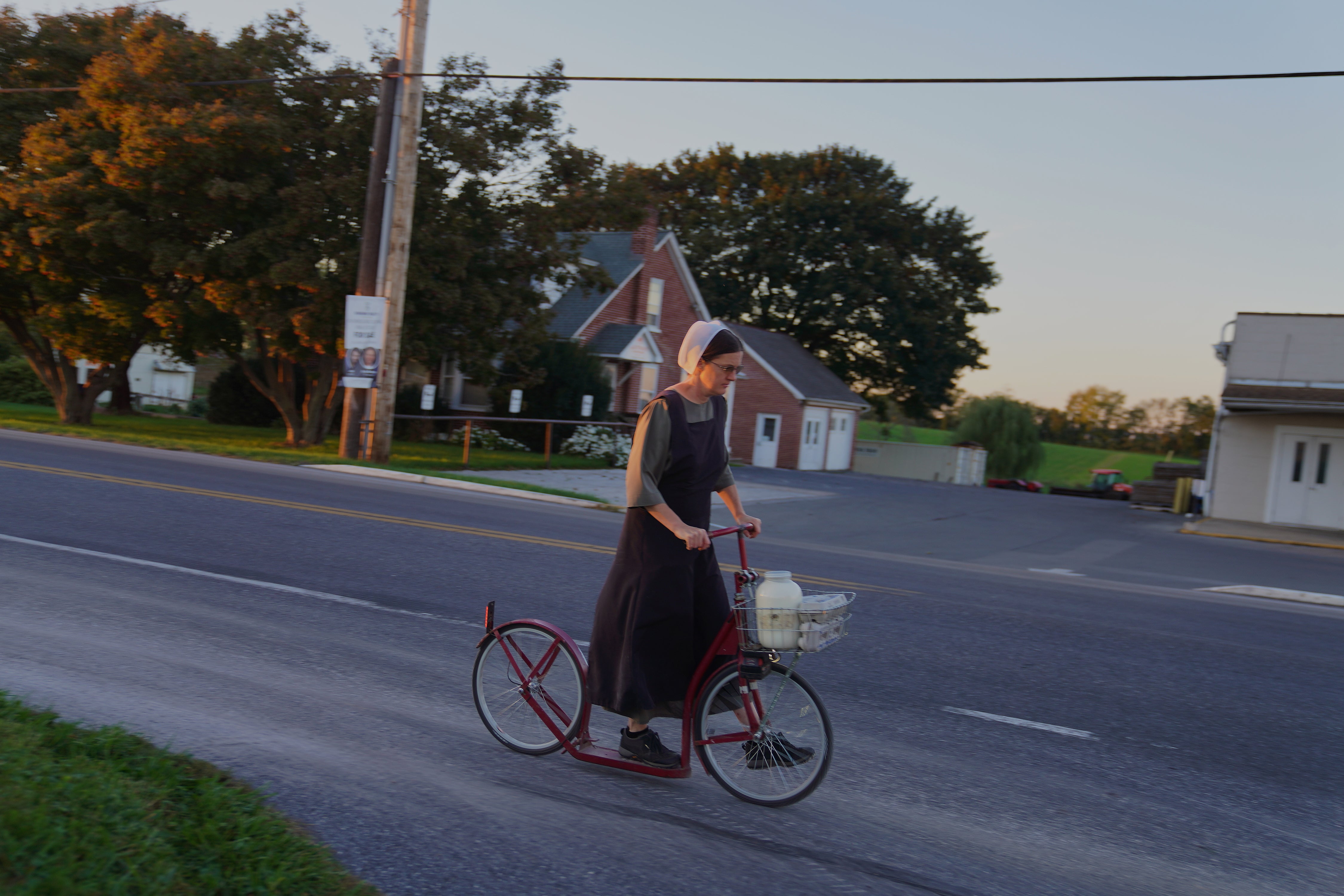 A woman from the Plain community rides a scooter in Intercourse