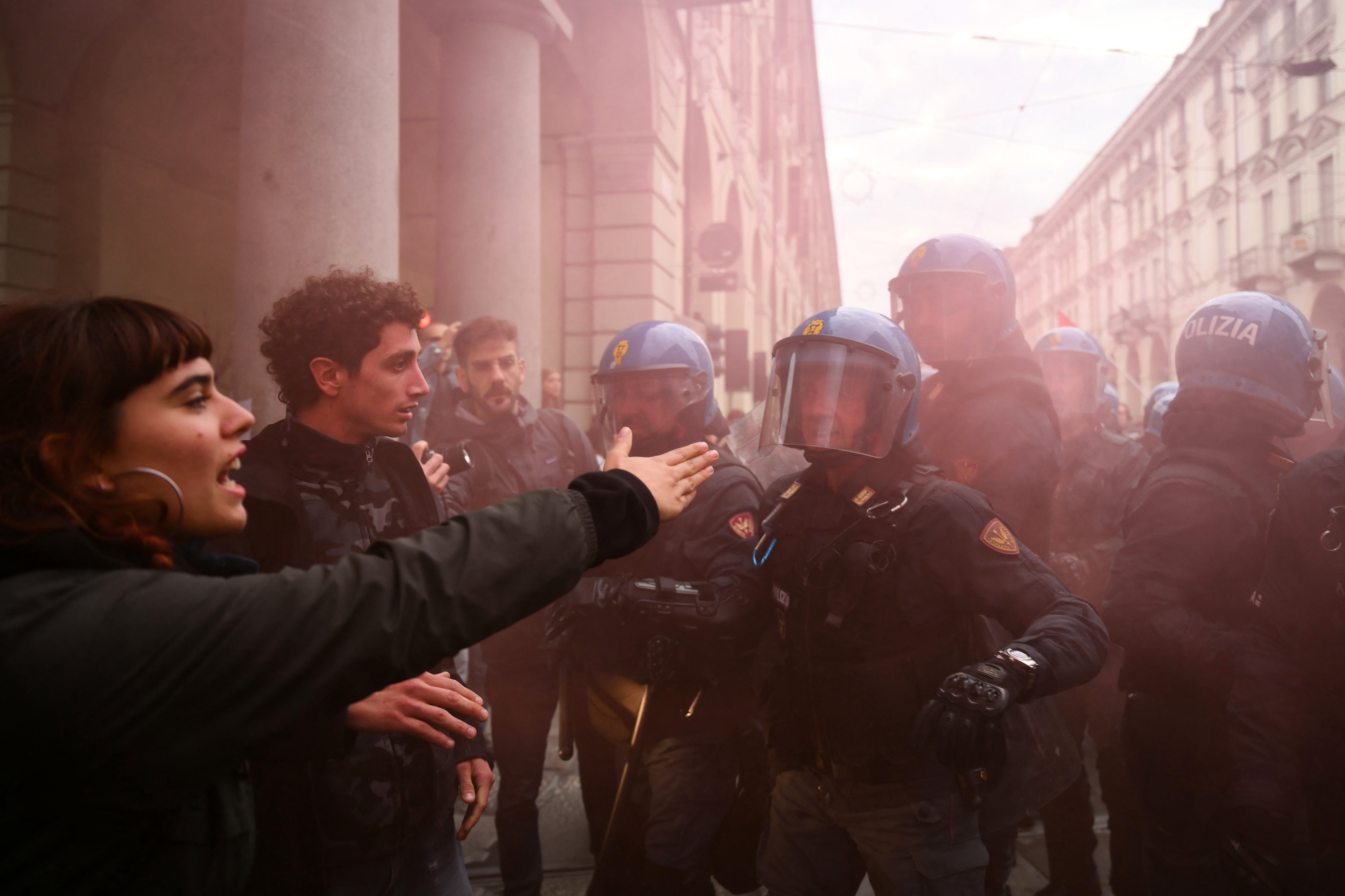 Students faces Italian police officers during a demonstration in Turin on Friday