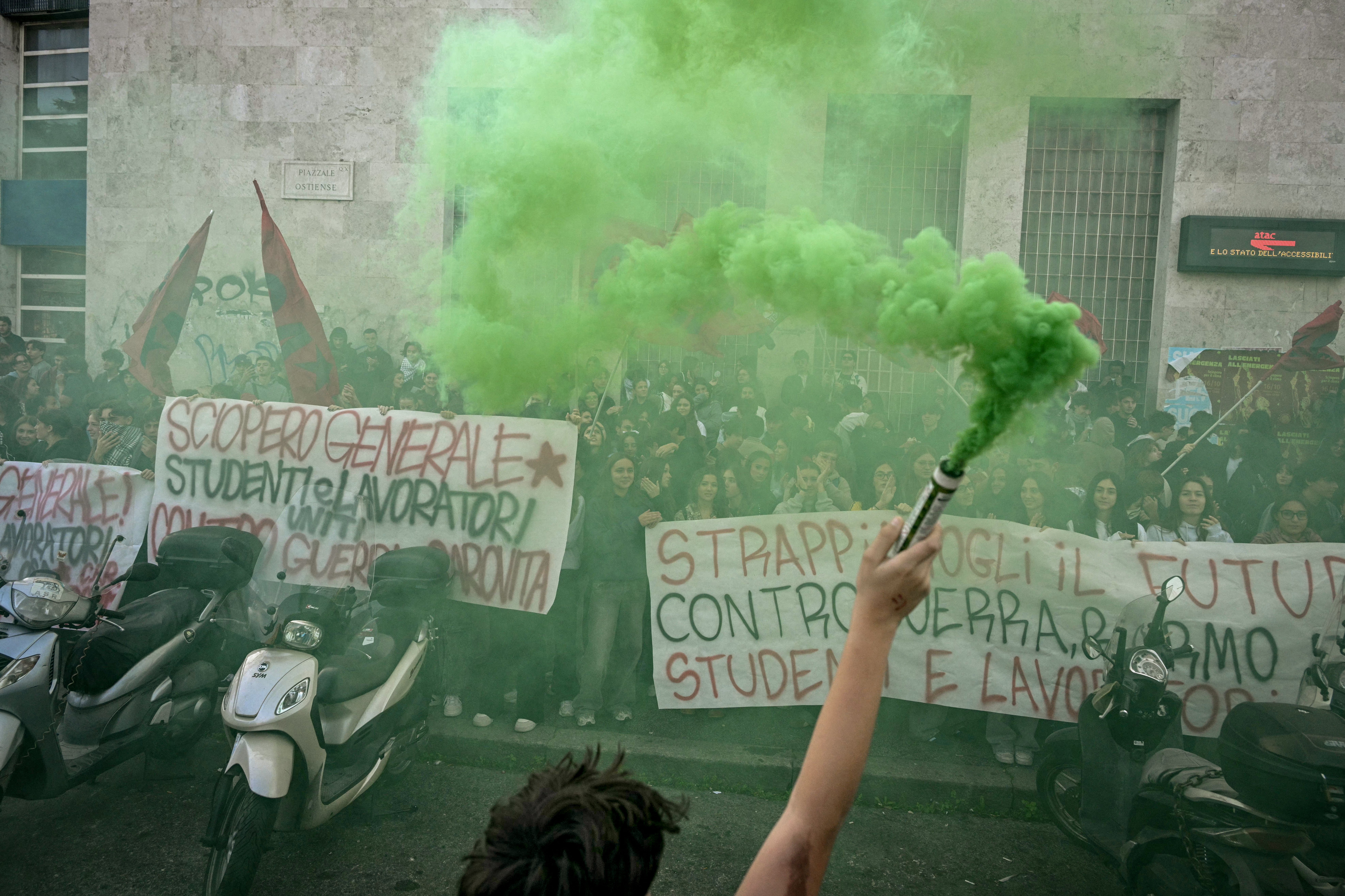People gather outside the Piramide metro station in Rome