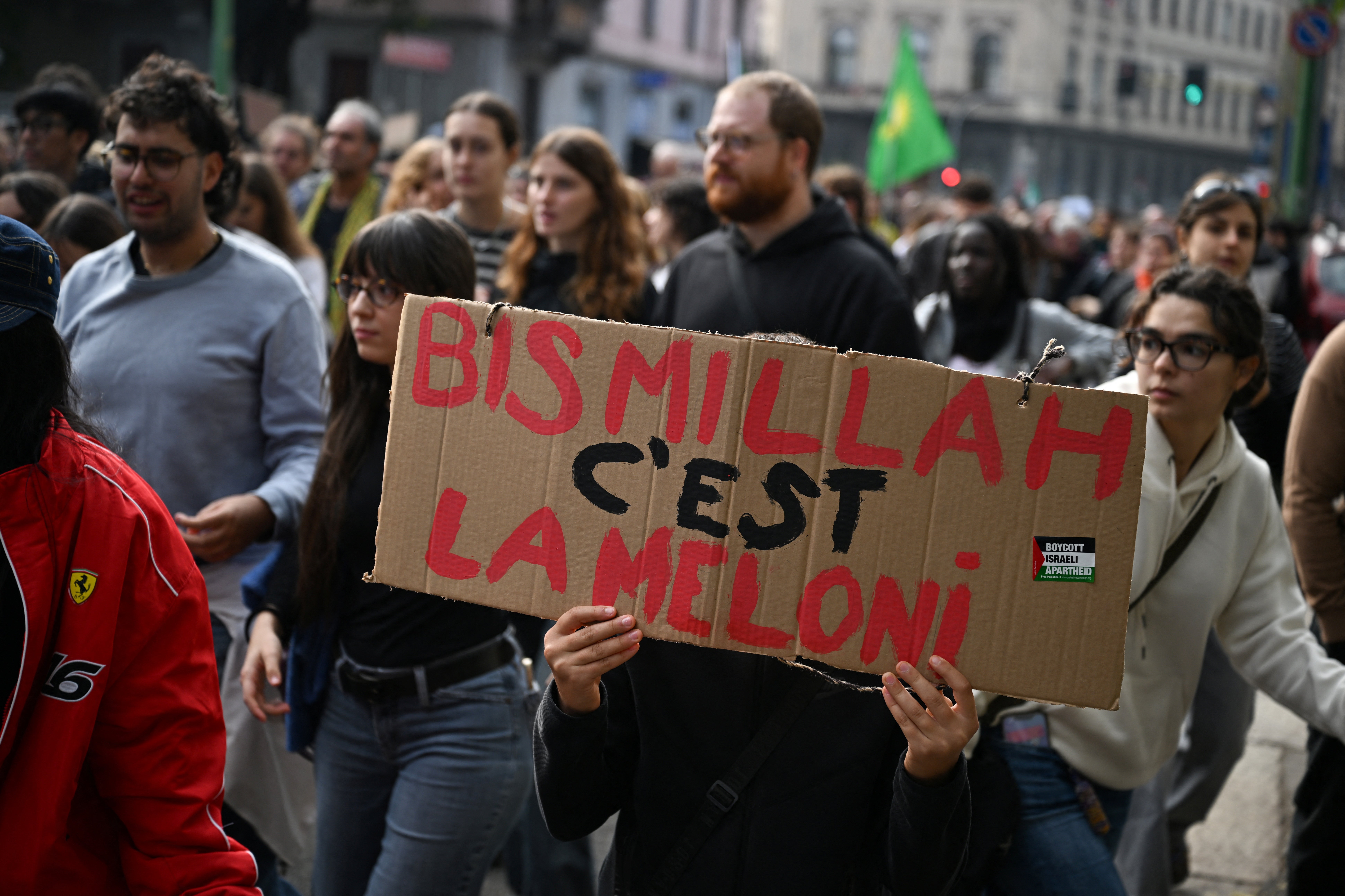 A protester holds a placard reading 