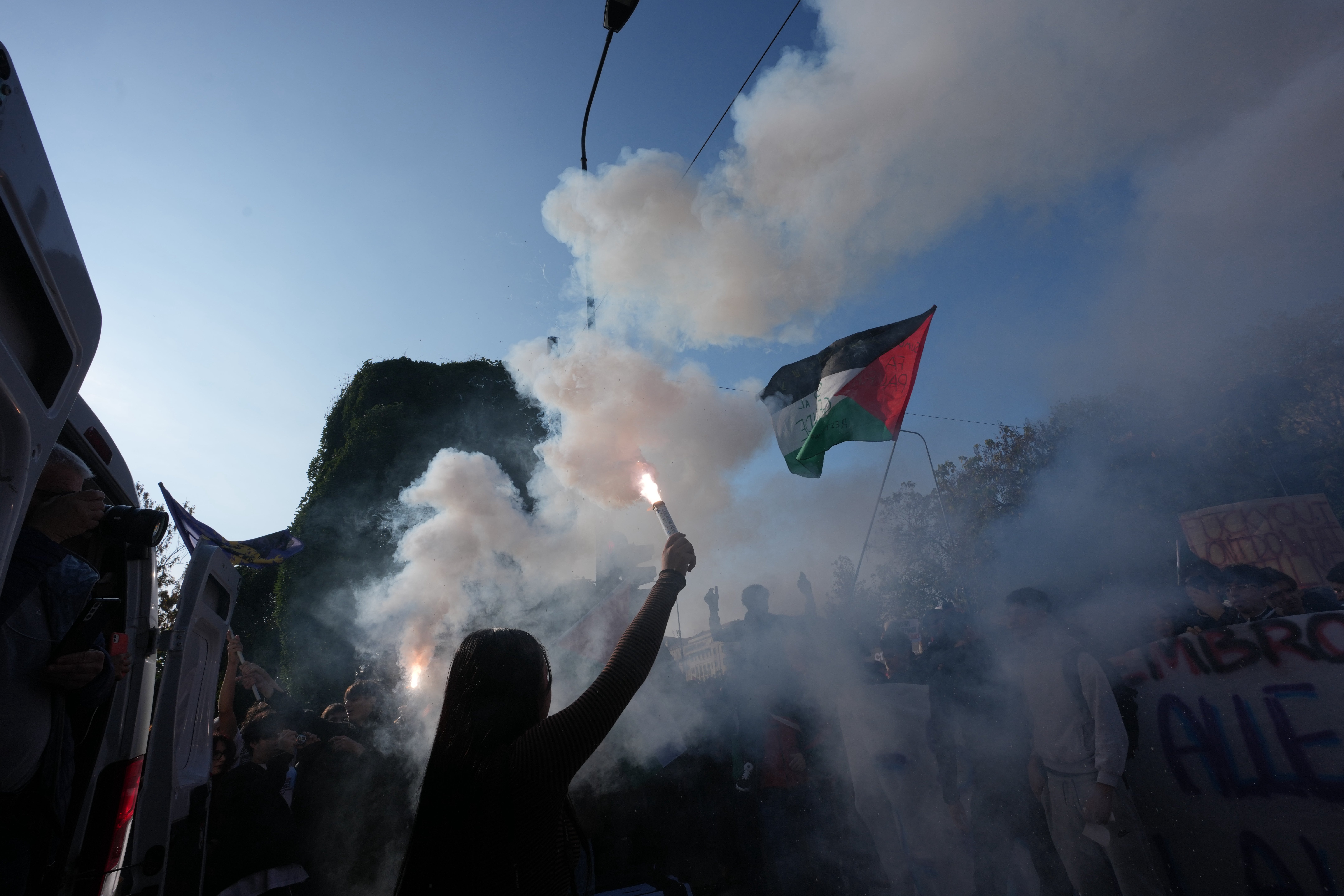 Workers, students and activists carrying a Palestinian flag demonstrate in Milan