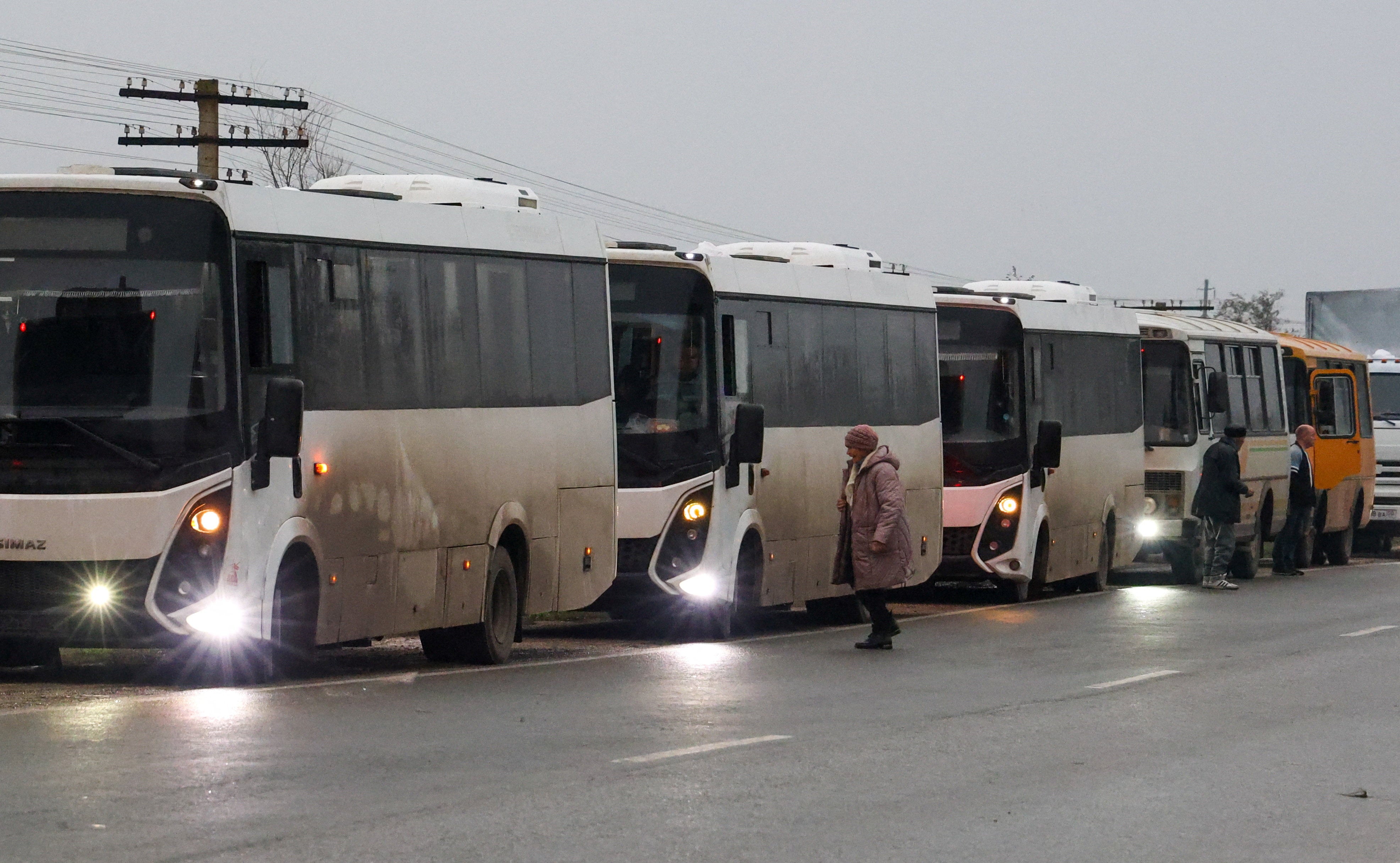 A humanitarian convoy carrying residents evacuated from Oleshky, during a brief stop