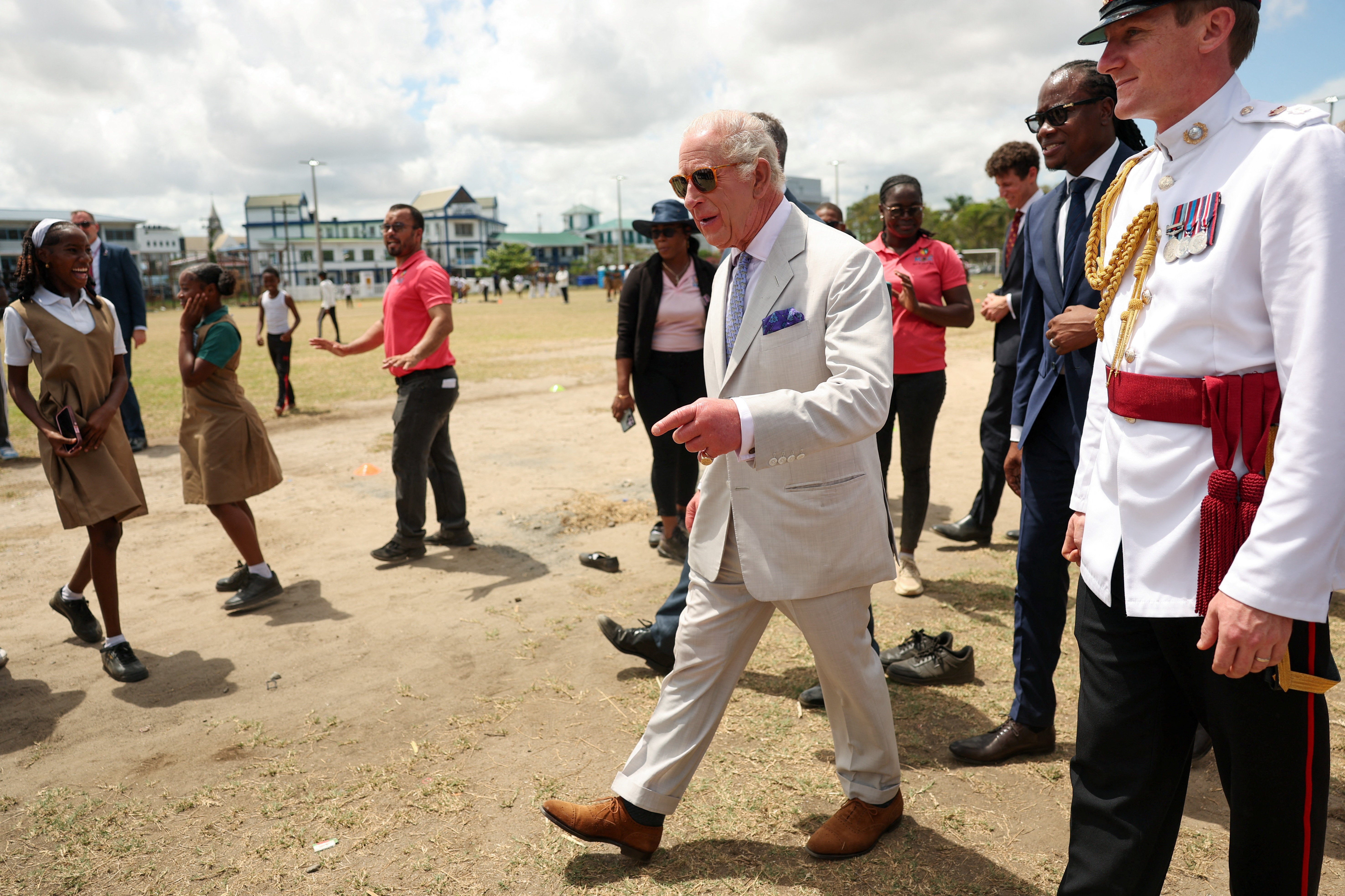 Charles with Steven Jacobs, as he greets youths in Promenade Gardens next to Independence Park in Georgetown
