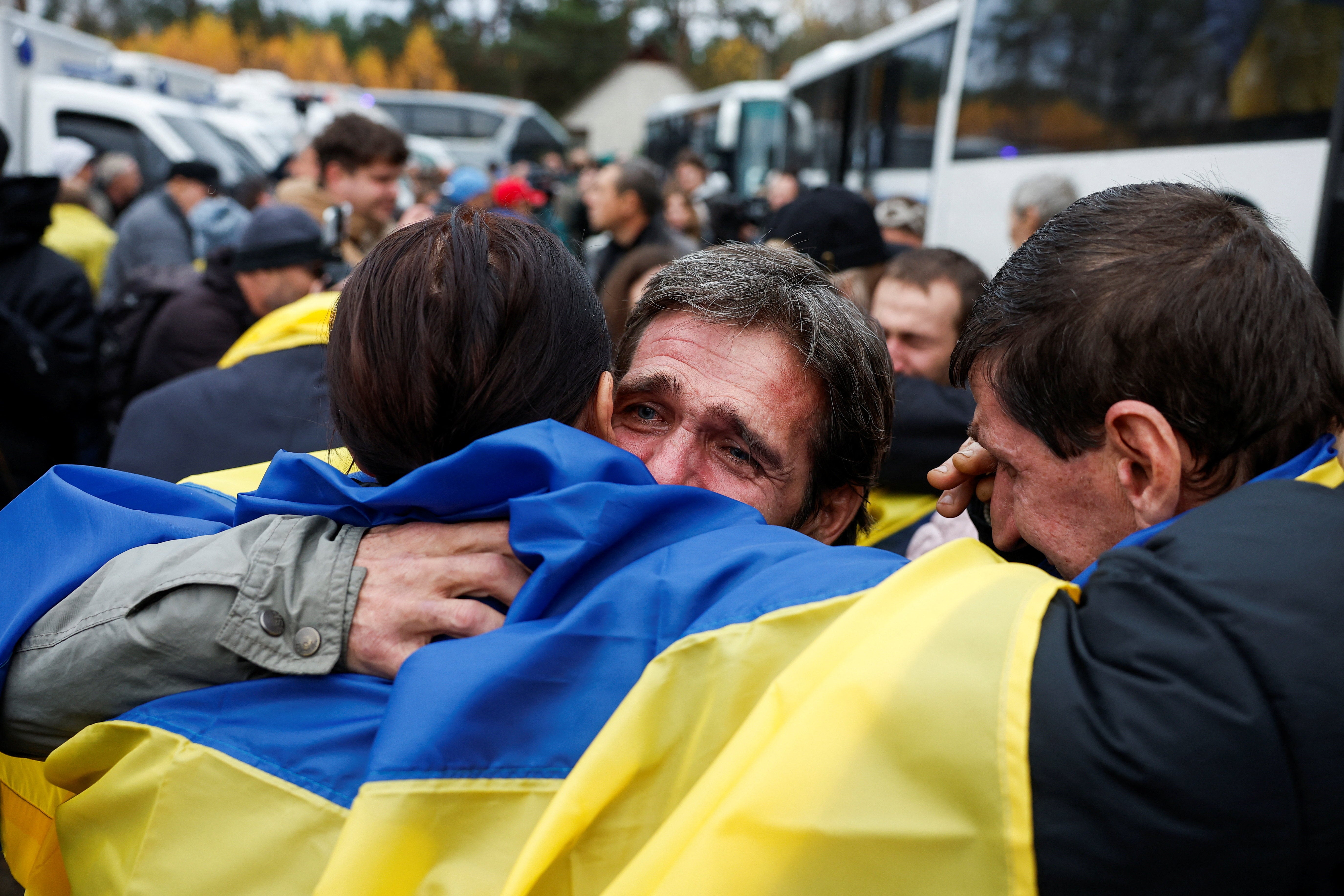 A Ukrainian family reuniting after being evacuated from Oleshky