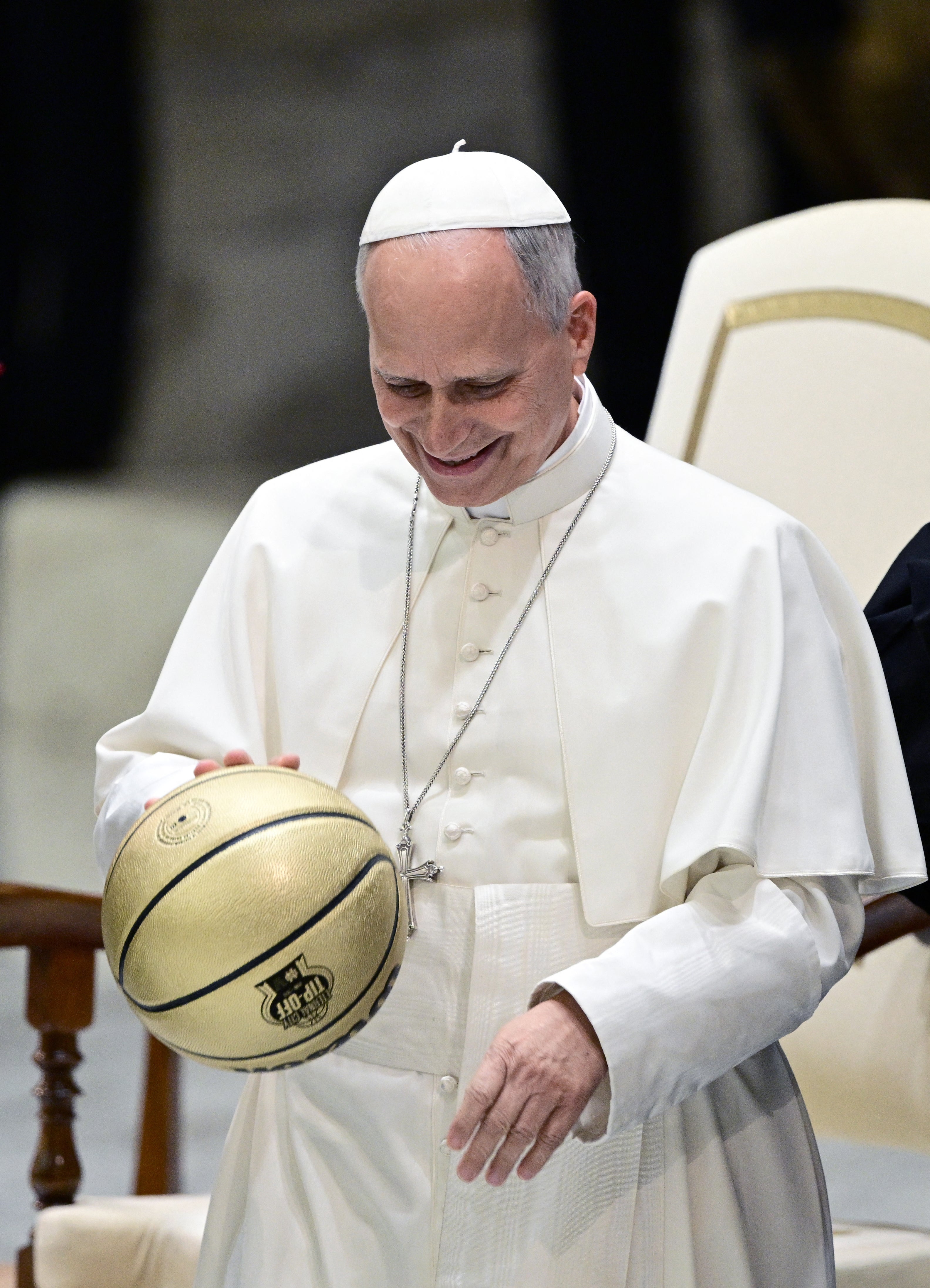 Pope Leo receives a basketball as a gift during an audience with delegations from Villanova University and the University of Notre Dame at the Paul VI Audience Hall in the Vatican on October 31, 2026