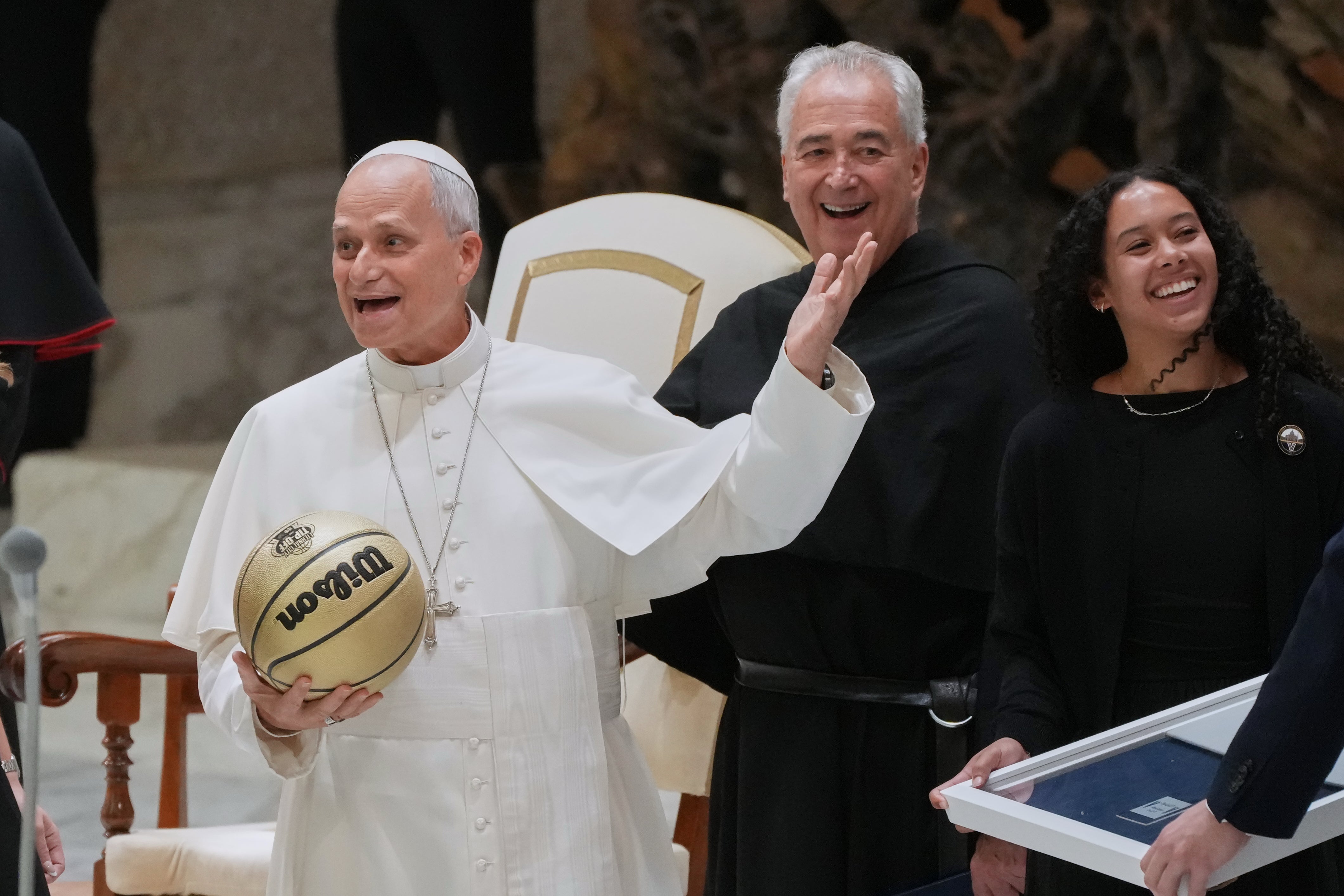 Basketball player Jasmine Bascoe along with Villanova University President Peter M. Donohue, present Pope Leo XIV with the basketball