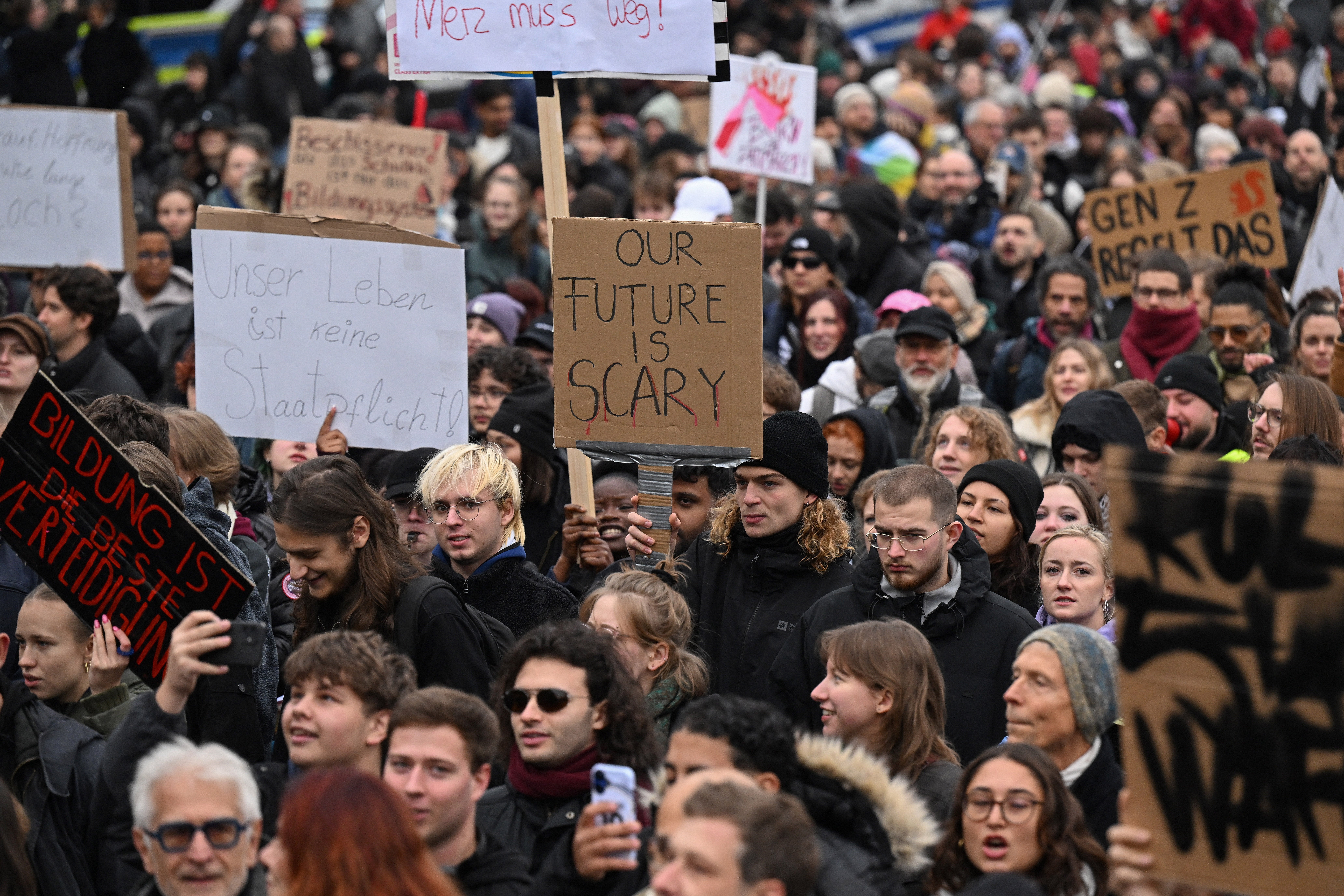 People hold up placards as they attend a demonstration organised by 