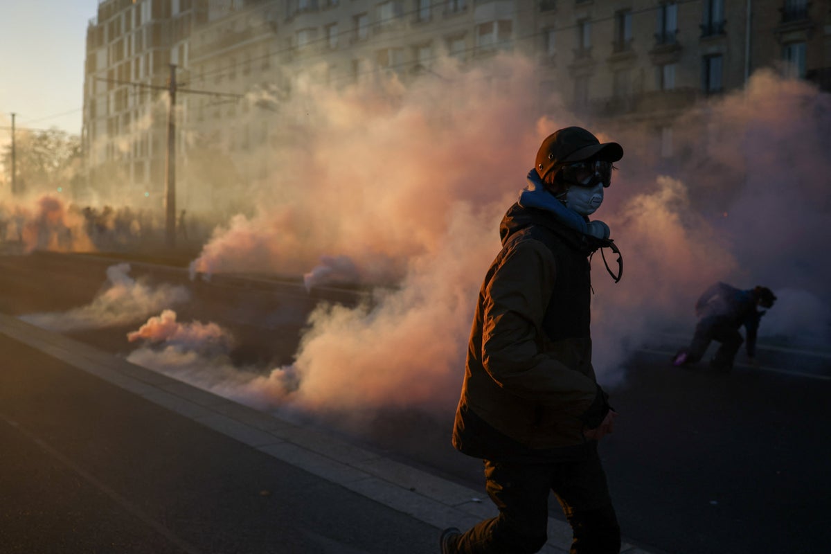 Paris police fire tear gas as more than 300,000 march across France in latest anti-government protests