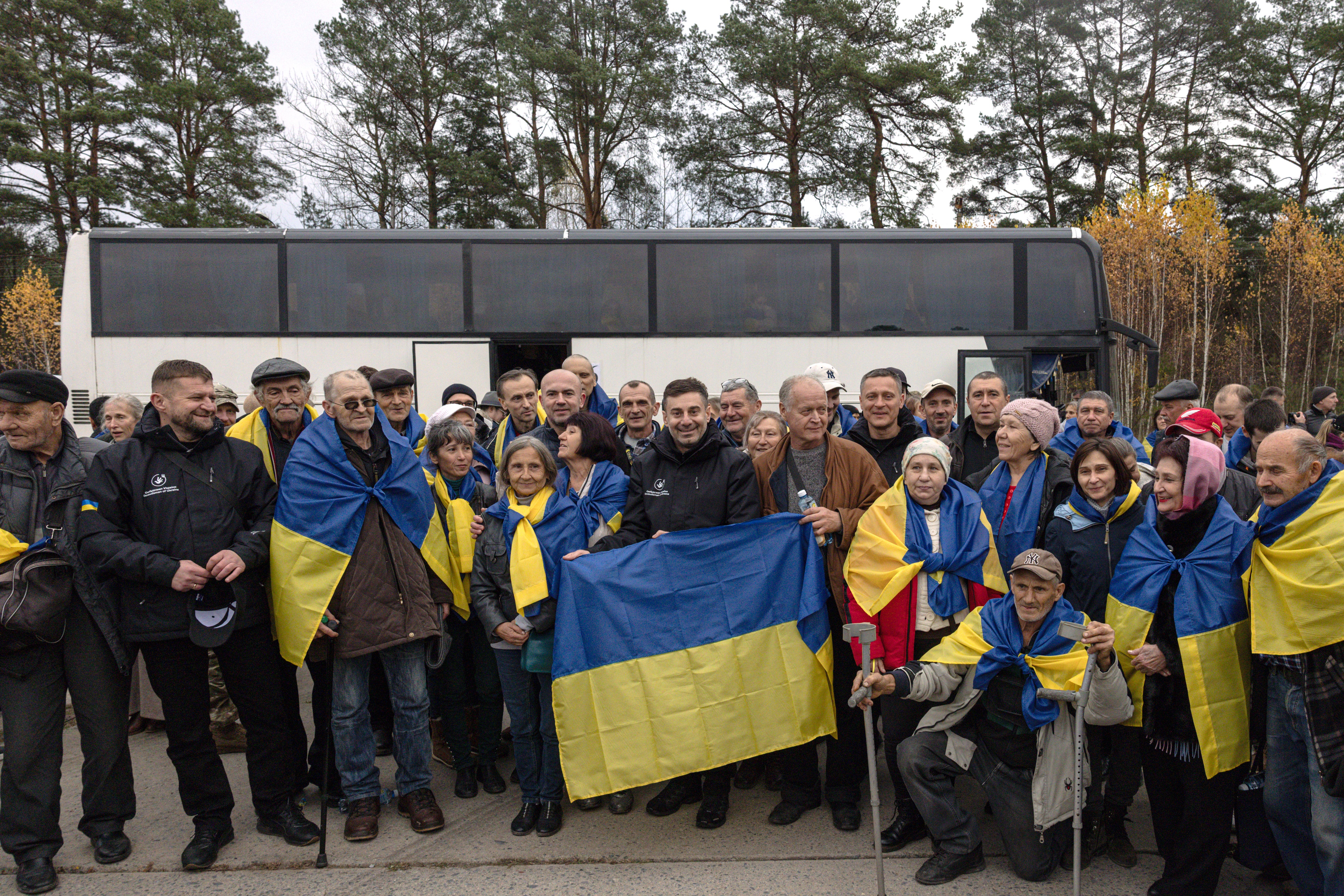 Ukraine’s Parliament Commissioner for Human Rights Dmytro Lubinets (C) with evacuees