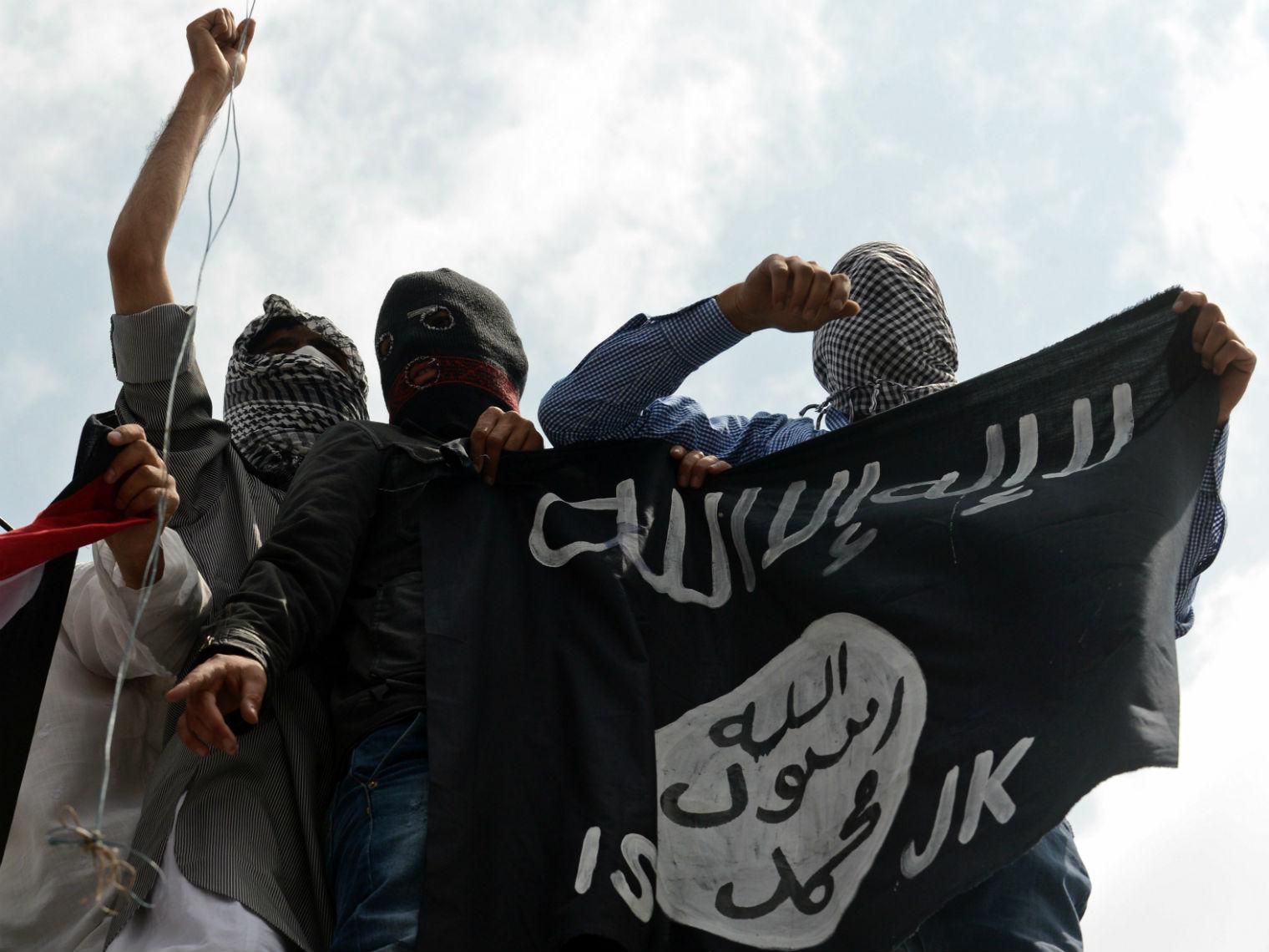 The flag of the terror group Isis is held up at a demonstration in Kashmir