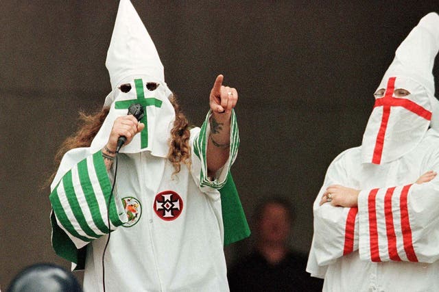 <p>File photo: A KKK rally on 21 August 1999 in Cleveland, Ohio. A middle school teacher in Pulaski County, Kentucky, was suspended after she allowed a student to dress up as a KKK grand wizard as part of a history project</p>