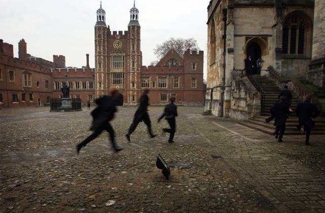 Boys run across the school yard of Eton College