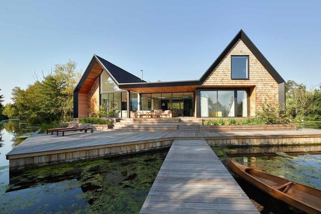 Clare and Patrick Michell have just finished building their three-bedroom, two-bathroom holiday home on stilts in the Norfolk Broads. Made of timber with timber shingles and huge sliding windows looking out on to a lagoon and other waterways all round, this house is quite something.