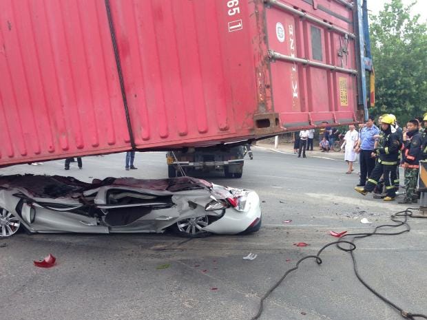 Crash victims in car flattened by shipping container 