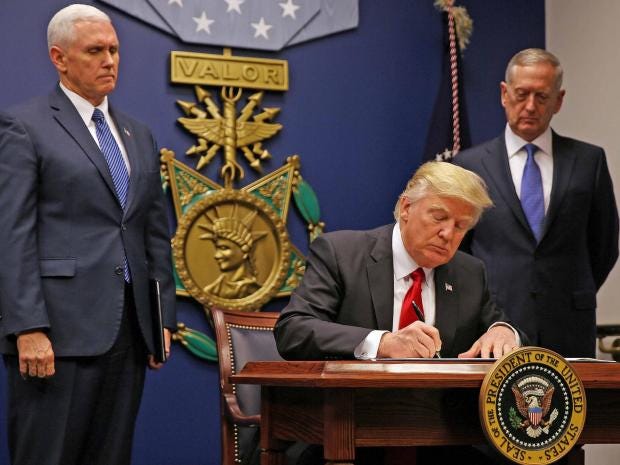 trump signing executive order for second travel ban.jpg