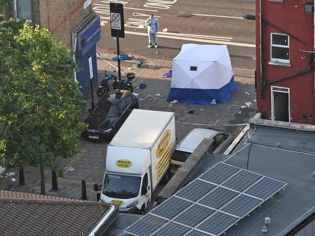 A police forensics officer stands next to a van involved in a suspected terror attack outside Finsbury Park Mosque