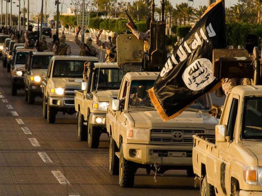 Isis fighters parade through in Sirte in 2015 