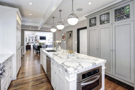 the-kitchen-is-bright-and-updated-with-marble-countertops-and-luxury-appliances.jpg