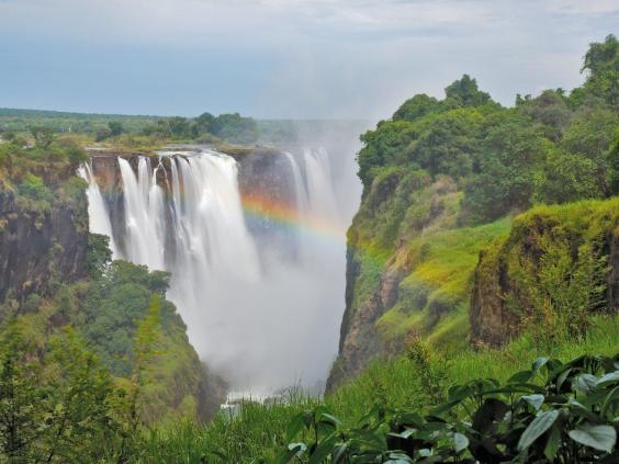Victoria Falls sits on the border between Zambia and Zimbabwe, where a giant curtain of water  often creates rainbows amid the mist and surrounding rainforest.  | The Independent