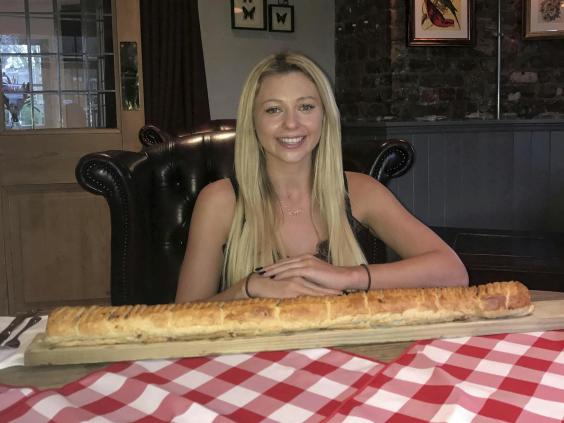 Woman Eats Giant Three Foot Long Sausage Roll Containing