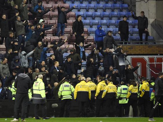 Wigan condemn violent clashes between fans after FA Cup ...