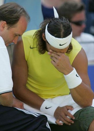Nadal struggles with a thigh injury before retiring from the Sydney International yesterday