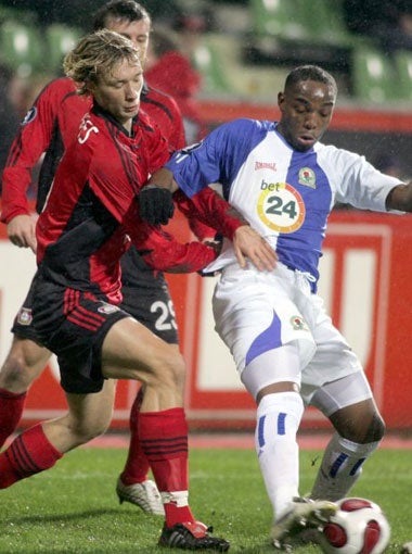 Rovers striker, Benni McCarthy, battles with the German defence
