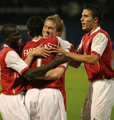 Arsenal players congratulate goal-scorer Fabregas