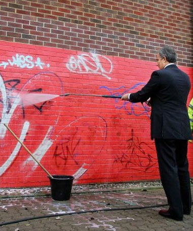 Tony Blair helps remove grafitti as he launches an action plan to combat anti-social behaviour