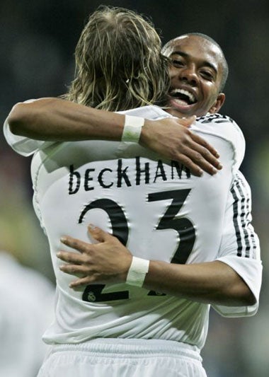 David Beckham and Robinho celebrate a goal at the Bernabeu