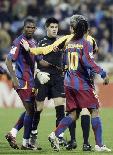 Barcelona's Samuel Eto'o (left) attempts to leave the field after racist abuse from opposing fans
