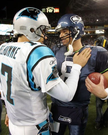 Panthers QB Jake Delhomme (No 17) congratulates opposite number Matt Hasselbeck (No 8)
