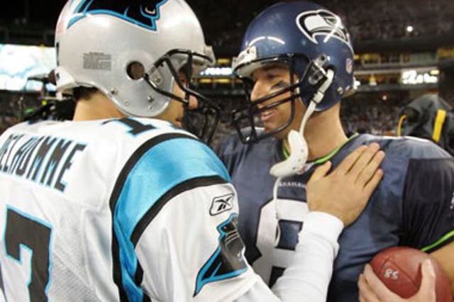 Panthers QB Jake Delhomme (No 17) congratulates opposite number Matt Hasselbeck (No 8)